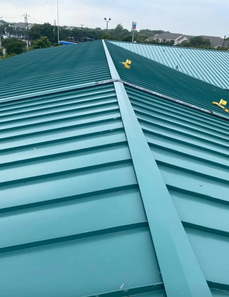 Green commercial metal roof ridge and valley for Metal Roof Repair in New Ipswich