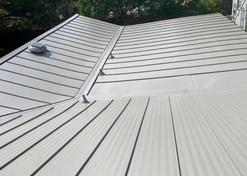 Solar attic fan installed on a metal roof for Roof Ventilation in New Ipswich